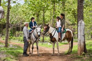Family on horseback riding through Nekupe's private reserve in Nicaragua